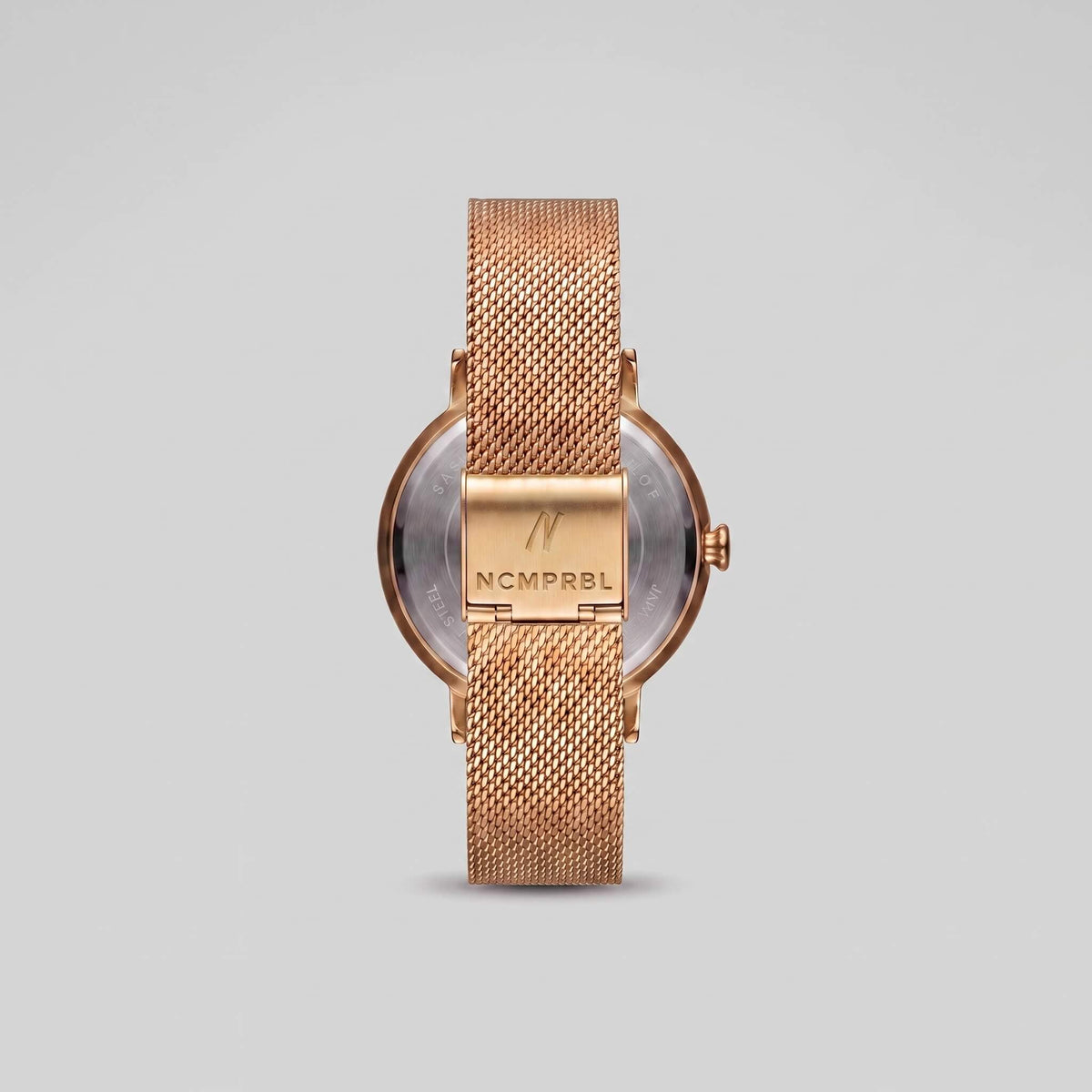 Gold Milanese mesh bracelet clasp with engraved NCMPRBL logo