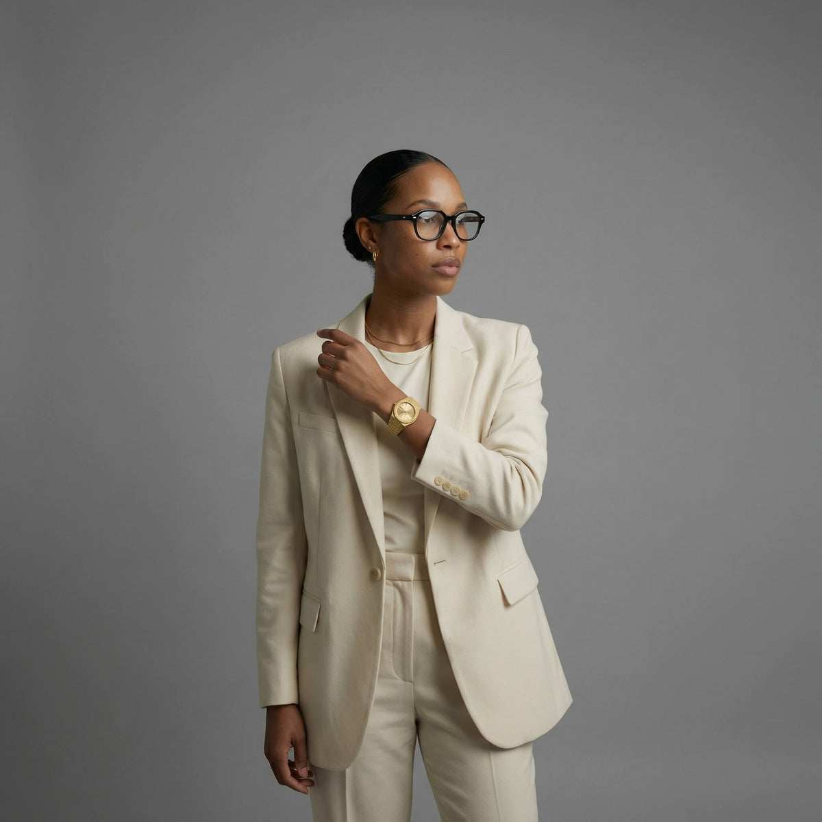 NCMPRBL Ascend Givré 40mm gold link bracelet watch on woman in beige suit with virtual try-on