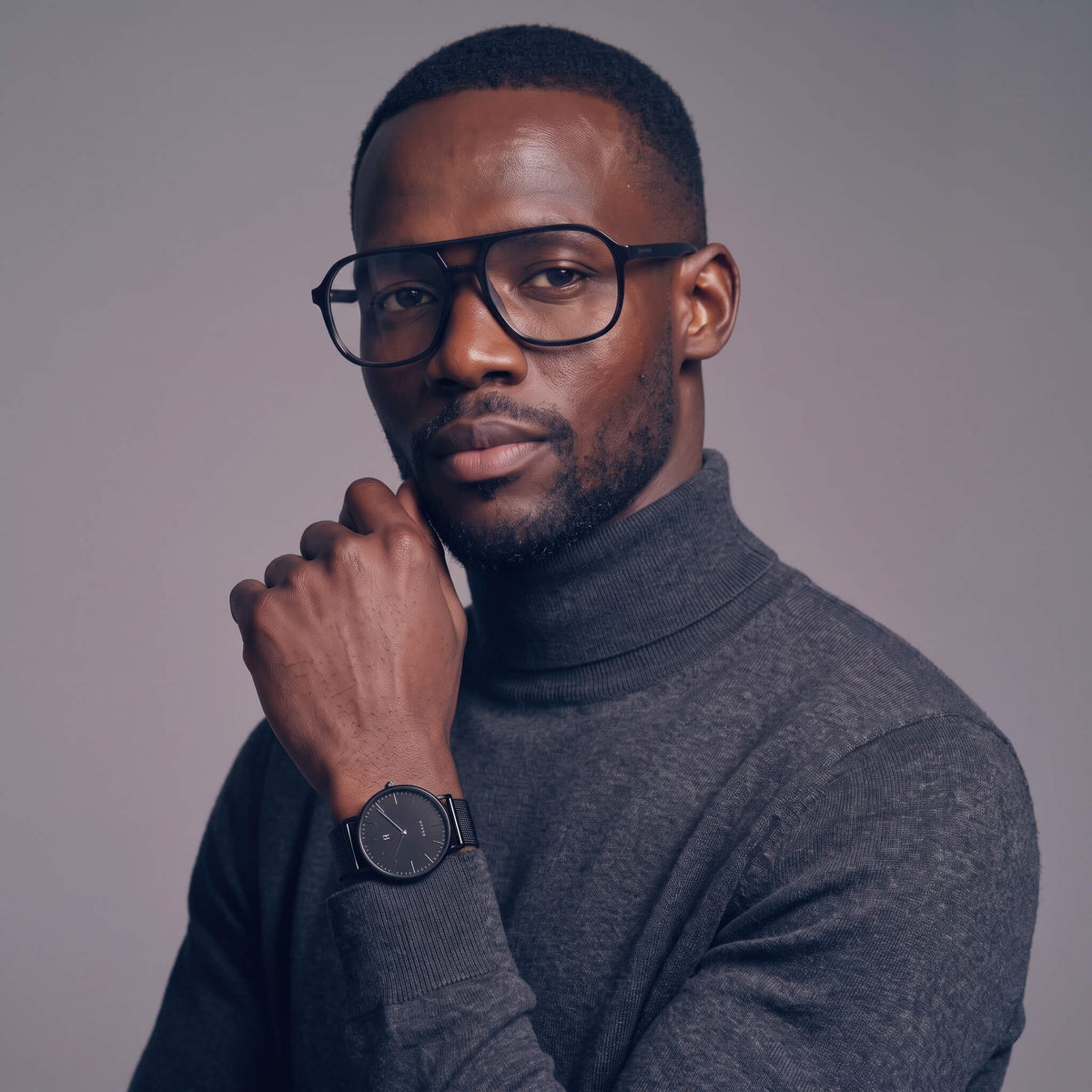Man wearing NCMPRBL Axis Onyx flat top eyeglasses and Advance Black Sands 40MM watch
