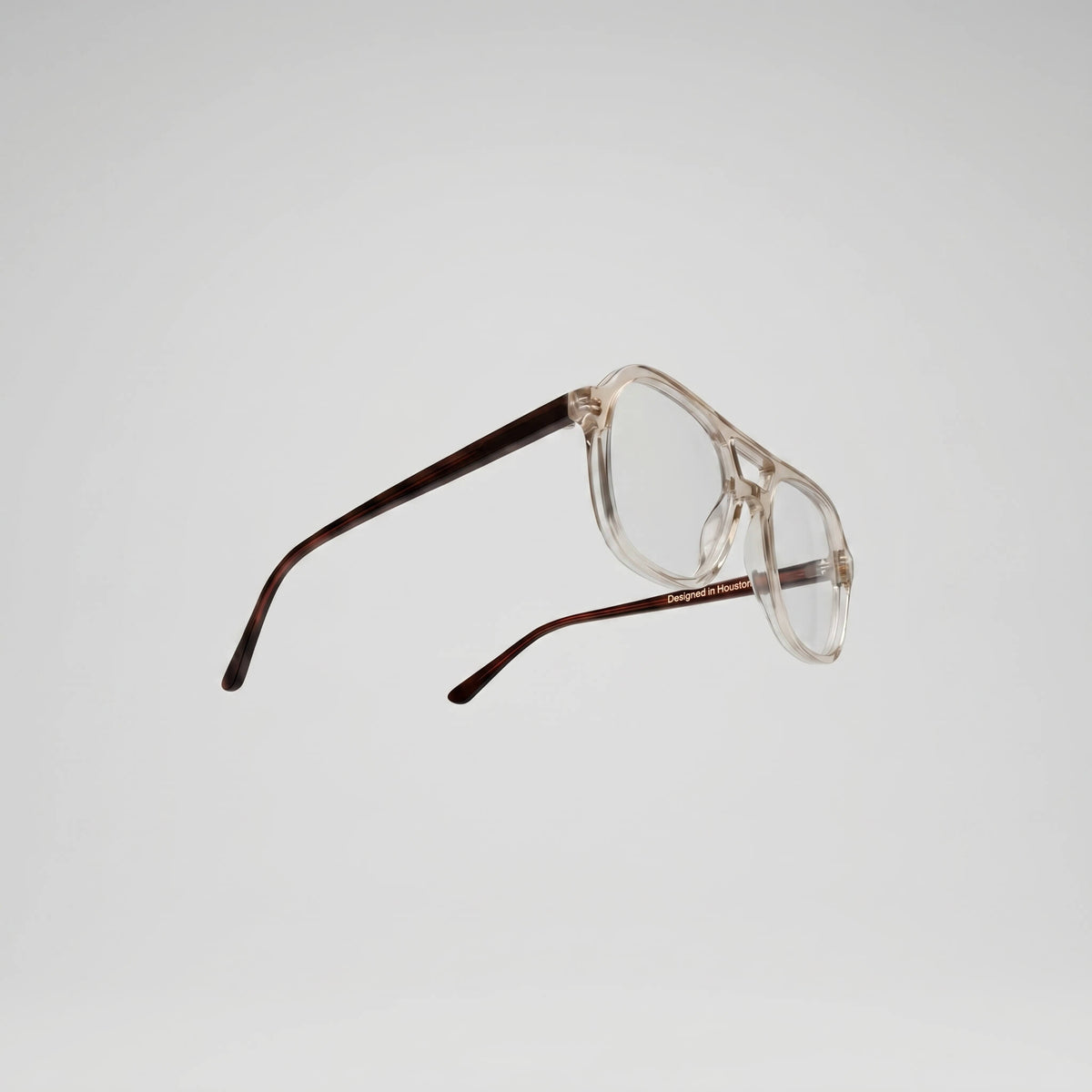 AXIS 03 eyeglasses flat top 53MM in smoke oak styled on wooden surface with blue light filter