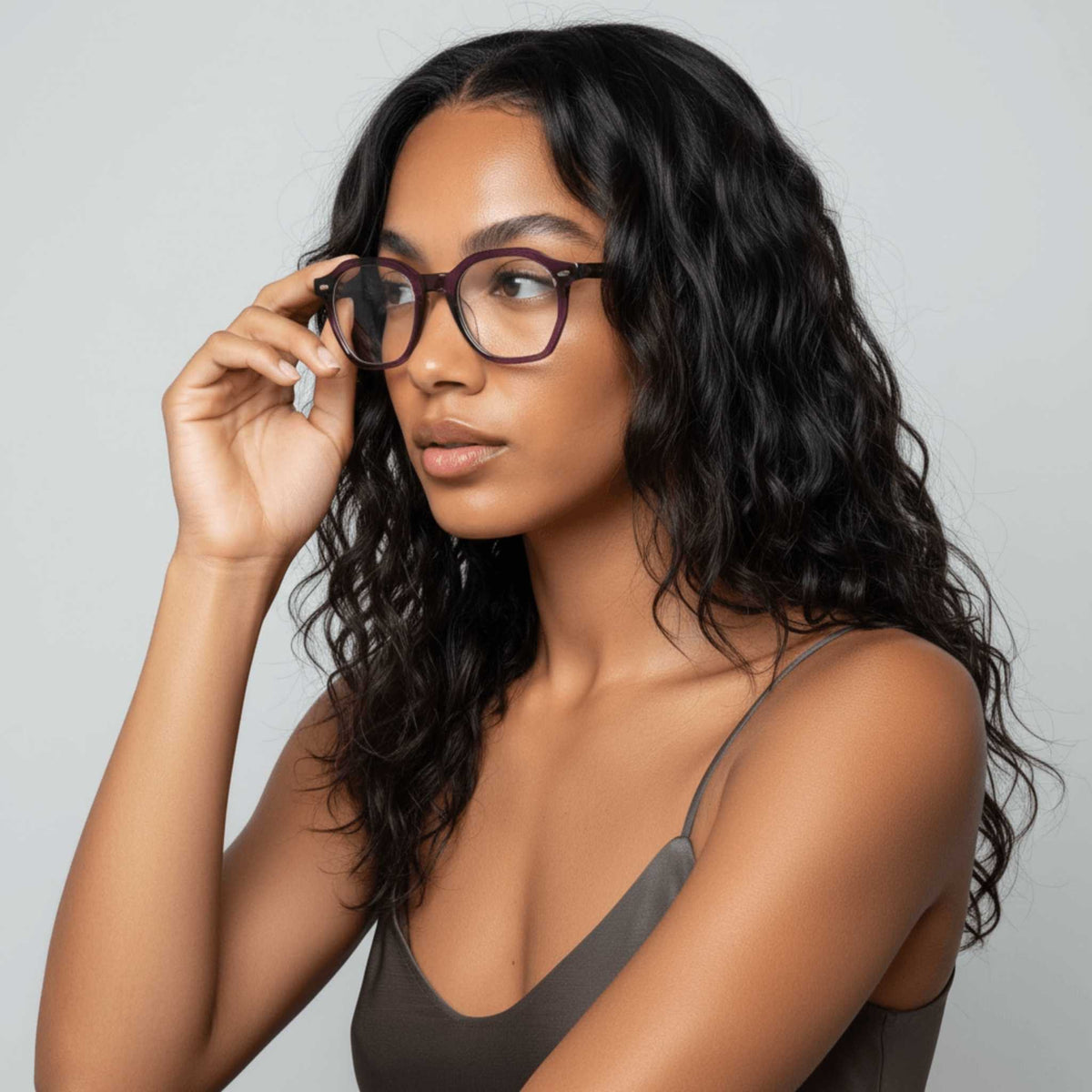 Woman wearing NCMPRBL Haze smoked violet geometric eyeglasses, three-quarter view