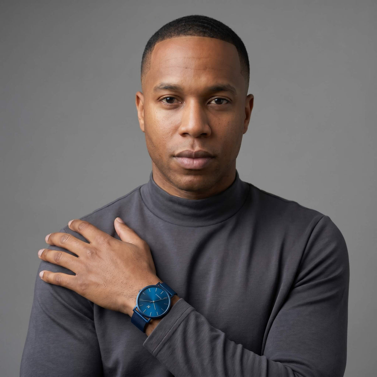 Advance Midnight Blue Mesh watch 36MM worn on wrist over dark gray turtleneck, try virtual watch on