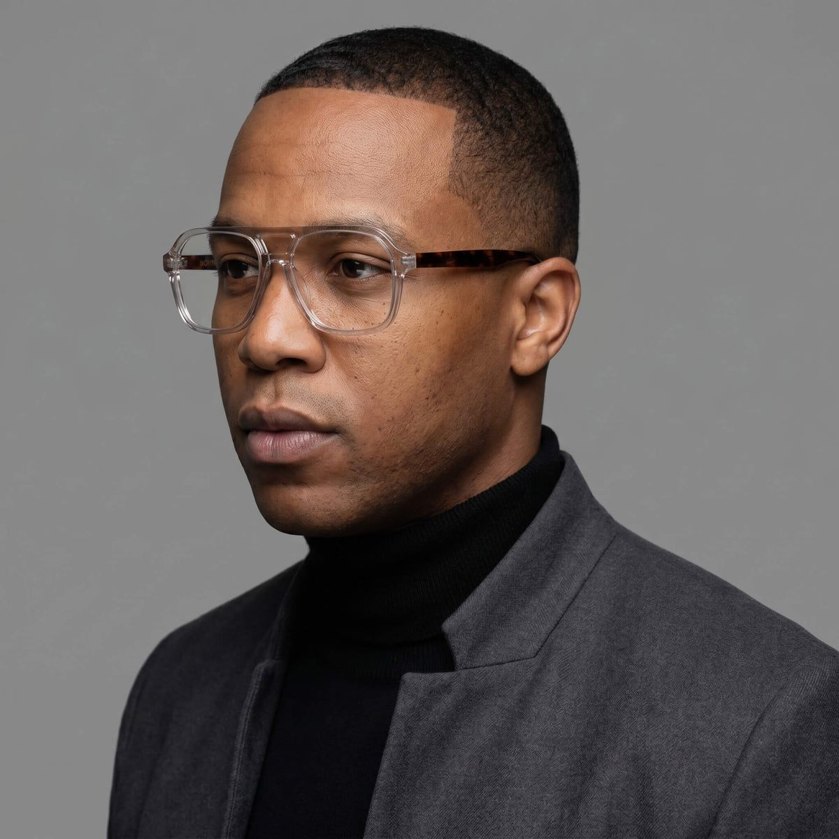 NCMPRBL AXIS 03 Smoke Oak minimalist eyeglasses worn by male model with virtual try-on in online studio